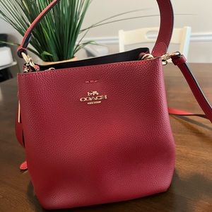 Coach purse! Ruby red, top handle bucket bag with crossbody strap attachment.